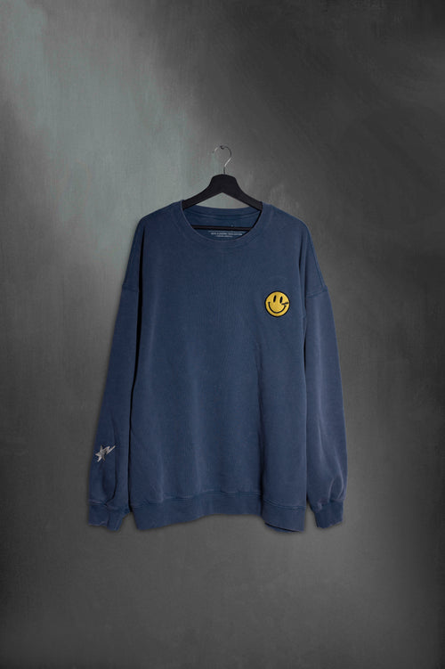 Buzo azul washed oversize con carita feliz bordada en el pecho
