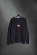 Buzo negro washed oversize con cartel Mushkana bordado en el frente
