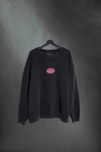 Buzo negro washed oversize con cartel Mushkana bordado en el frente