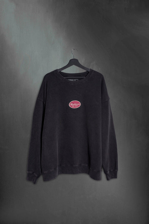 Buzo negro washed oversize con cartel Mushkana bordado en el frente
